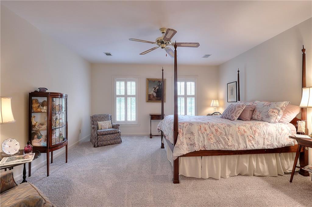 600 River Cove Road Social Circle, GA 30025 - Photo 28 of 45 a spacious bedroom with a bed couch and a window
