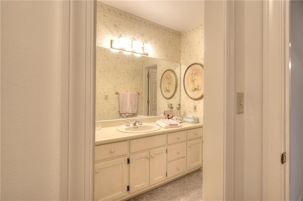 600 River Cove Road Social Circle, GA 30025 - Photo 30 of 45 a en suite bathroom with a double vanity sink a mirror and a