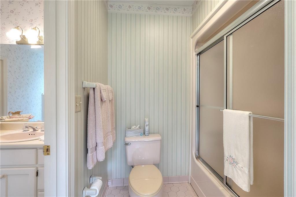600 River Cove Road Social Circle, GA 30025 - Photo 34 of 45 a bathroom with a granite countertop sink and a mirror