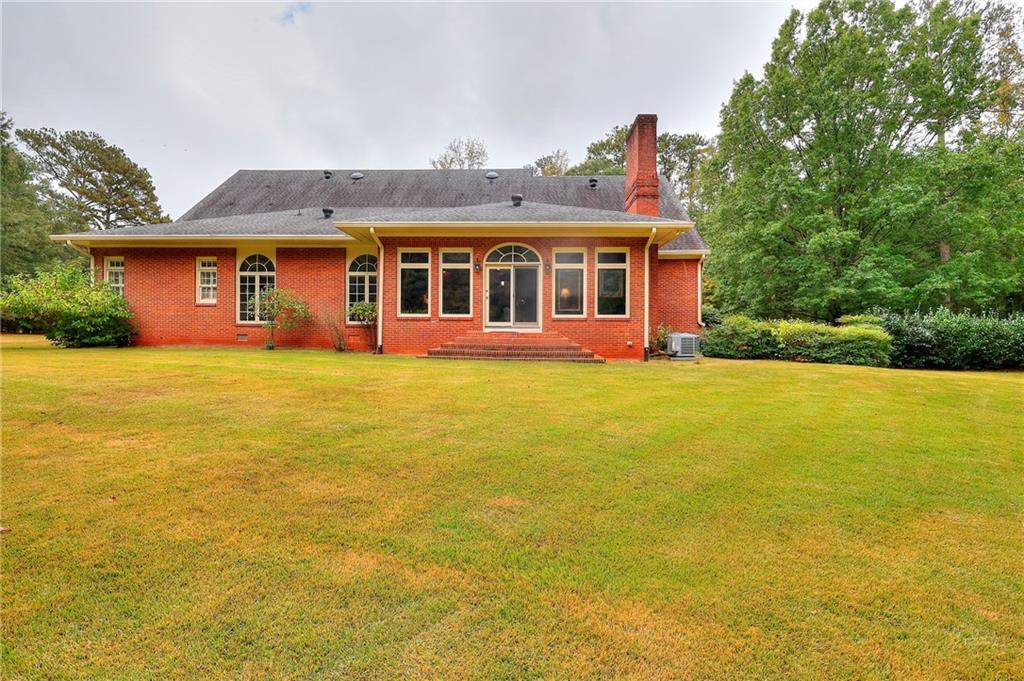 600 River Cove Road Social Circle, GA 30025 - Photo 42 of 45 a front view of house with yard and trees in the background