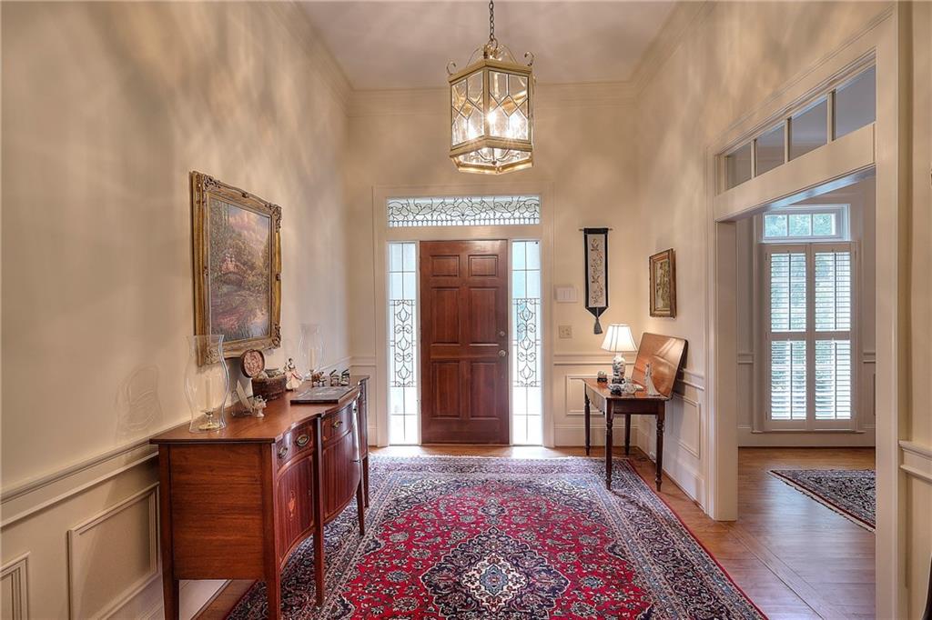 600 River Cove Road Social Circle, GA 30025 - Photo 7 of 45 a living room with furniture and a chandelier