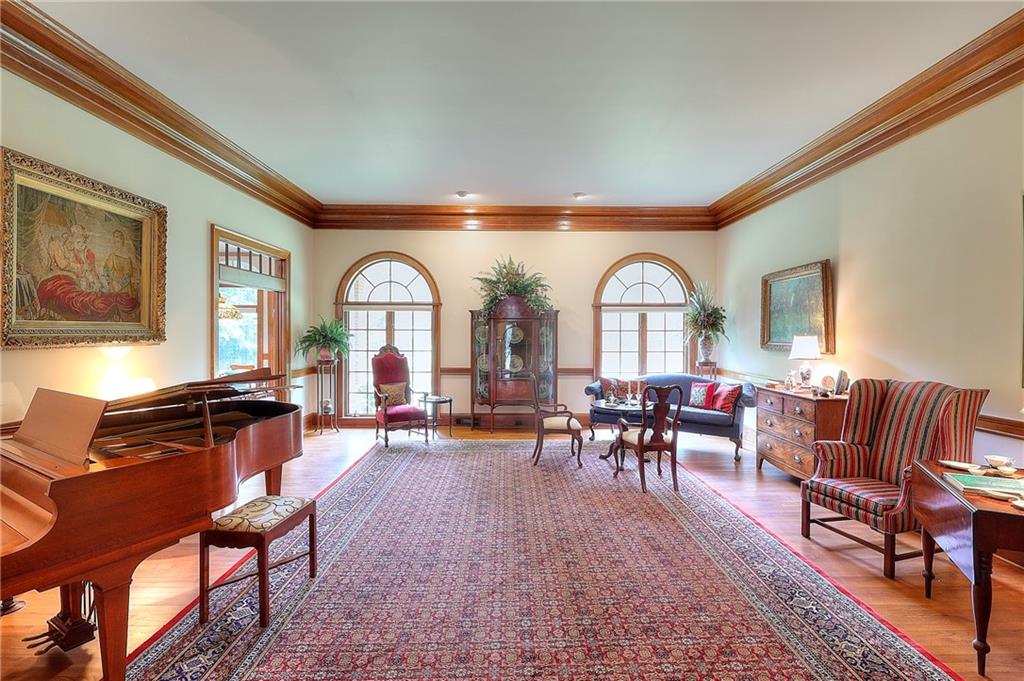 600 River Cove Road Social Circle, GA 30025 - Photo 8 of 45 a living room with furniture a clock on the table and wooden floor