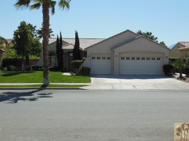 68451 Riviera Road Cathedral City, CA 92234 - Photo 2 of 8 a view of a house with a yard and a palm tree