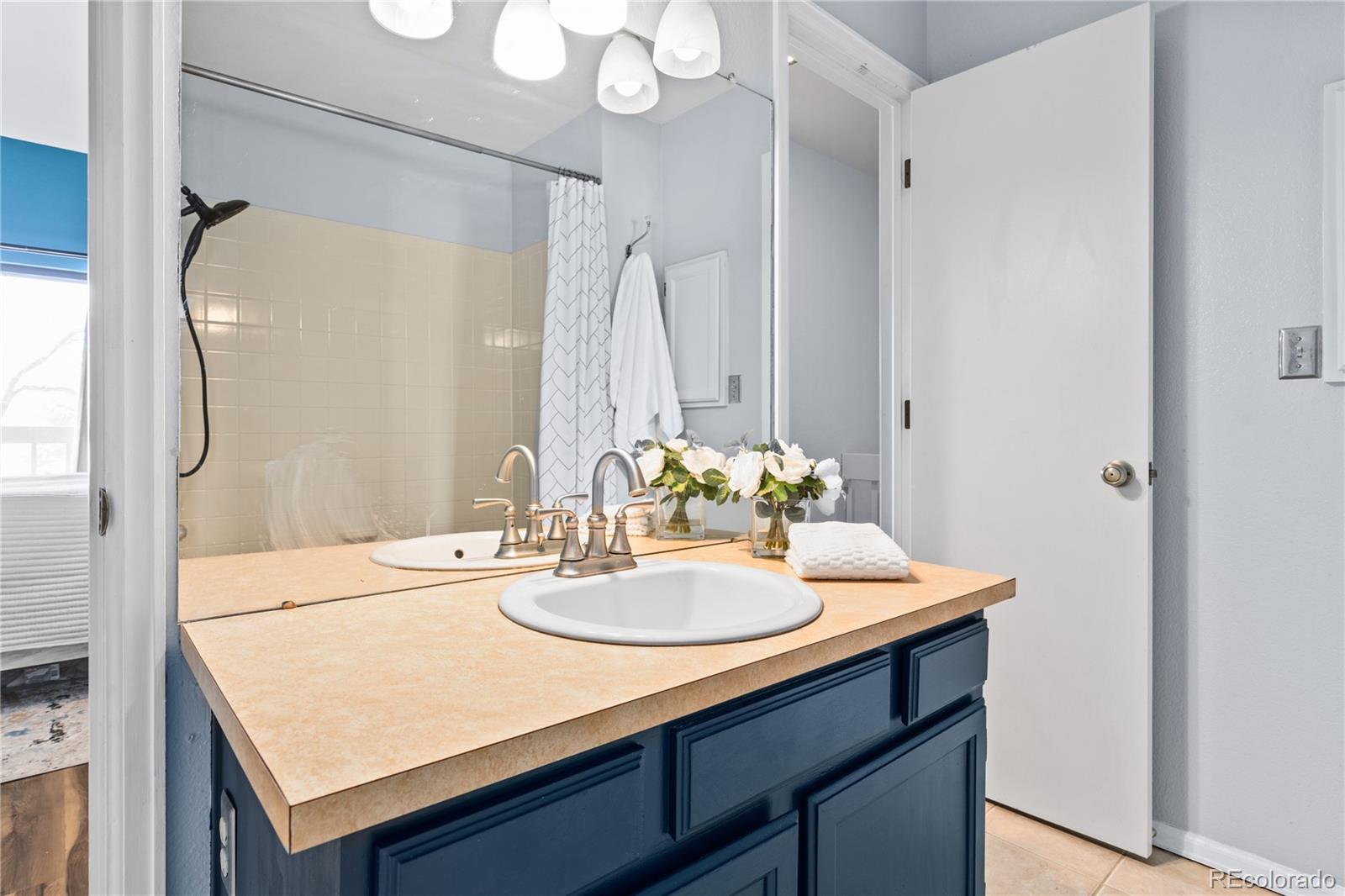 5092 Buckingham Road Boulder, CO 80301 - Photo 17 of 25 a bathroom with a sink vanity granite and a mirror