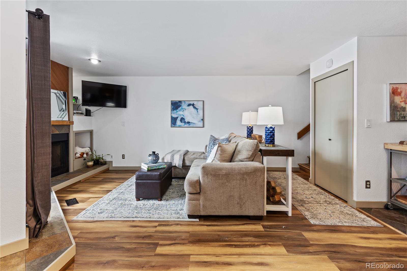 5092 Buckingham Road Boulder, CO 80301 - Photo 3 of 25 a living room with furniture and a flat screen tv