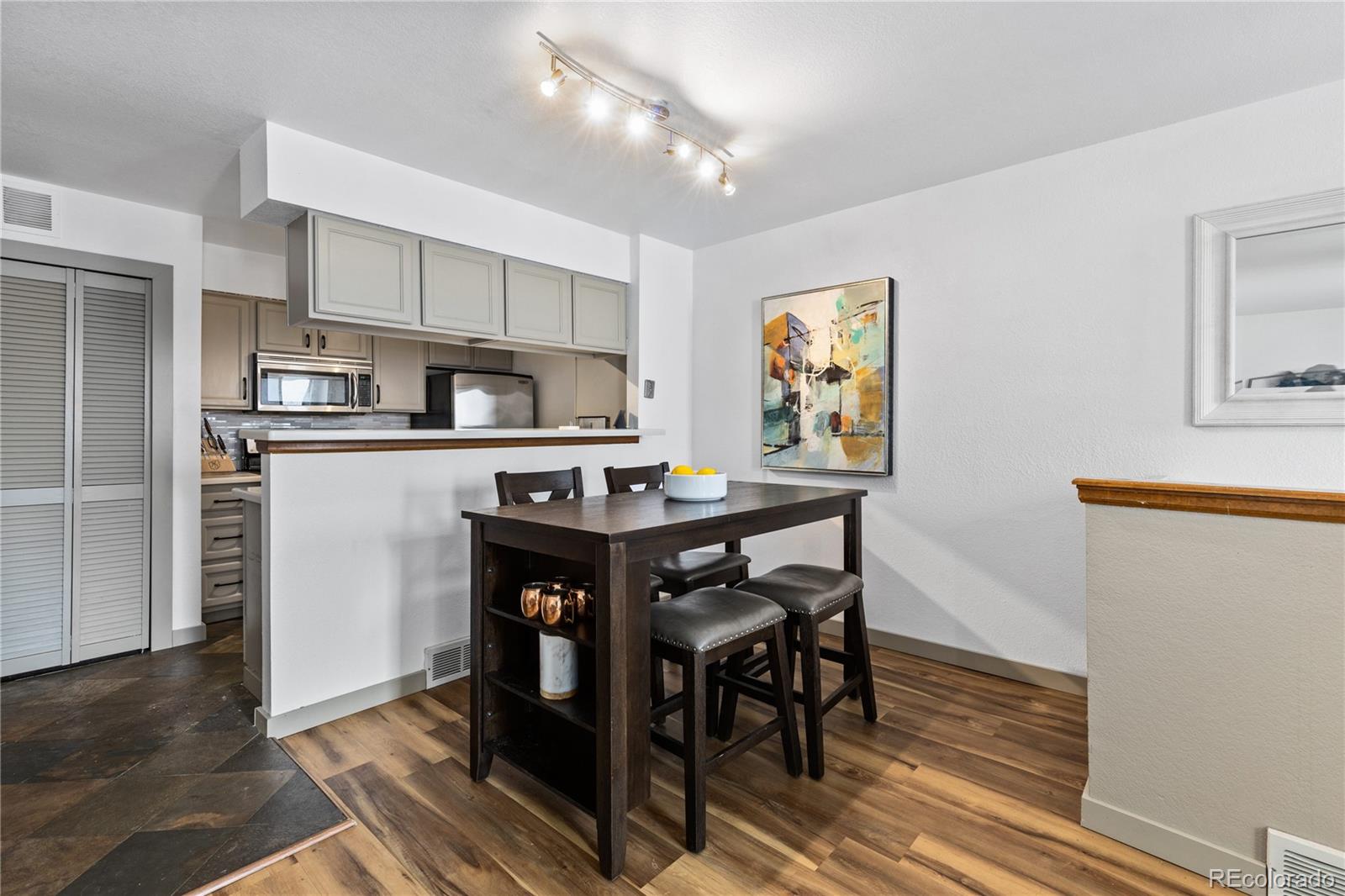 5092 Buckingham Road Boulder, CO 80301 - Photo 7 of 25 a kitchen with stainless steel appliances granite countertop a table chairs refrigerator and sink