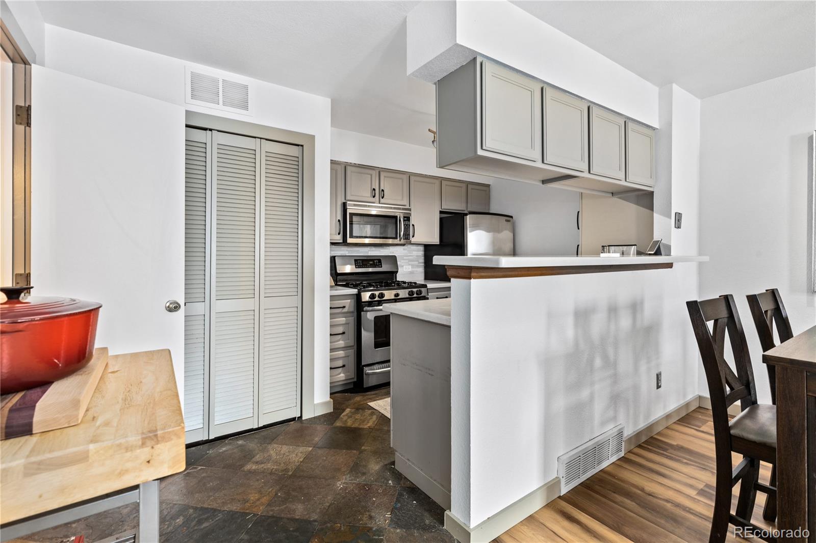 5092 Buckingham Road Boulder, CO 80301 - Photo 8 of 25 a kitchen with stainless steel appliances granite countertop a refrigerator and a stove top oven