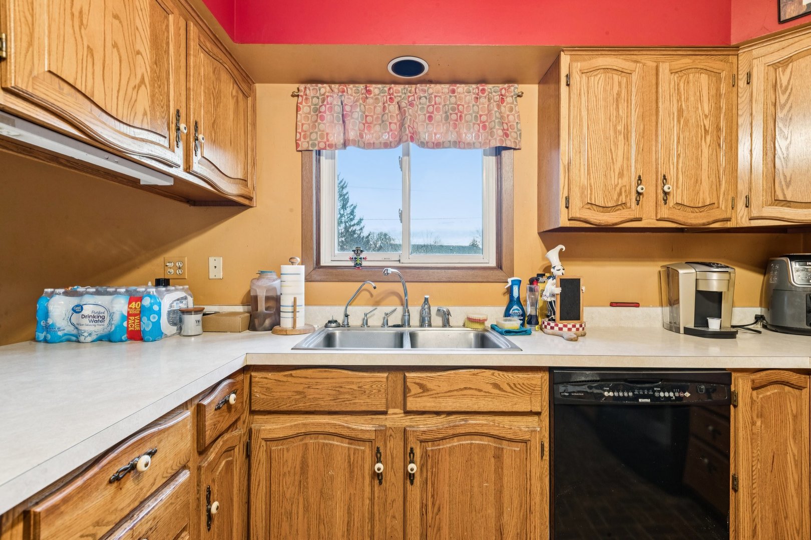 25283 Timber Lane Lake Villa, IL 60046 - Photo 13 of 49 a kitchen with stainless steel appliances granite countertop a sink a stove and a wooden cabinets