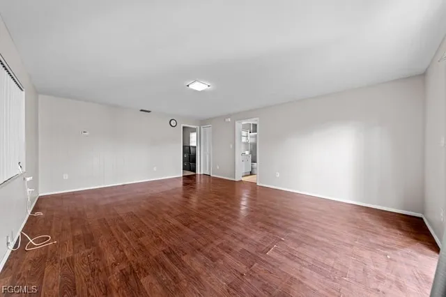 a view of an empty room and wooden floor