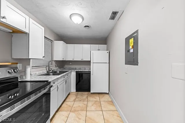 a kitchen with a sink a stove and cabinets