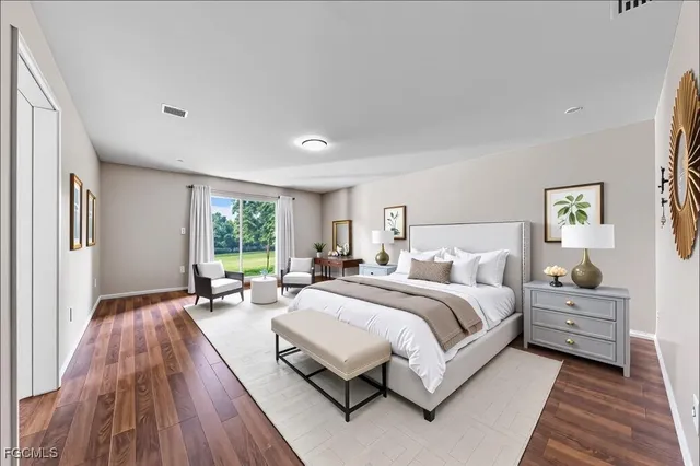 a spacious bedroom with a bed couch and a window