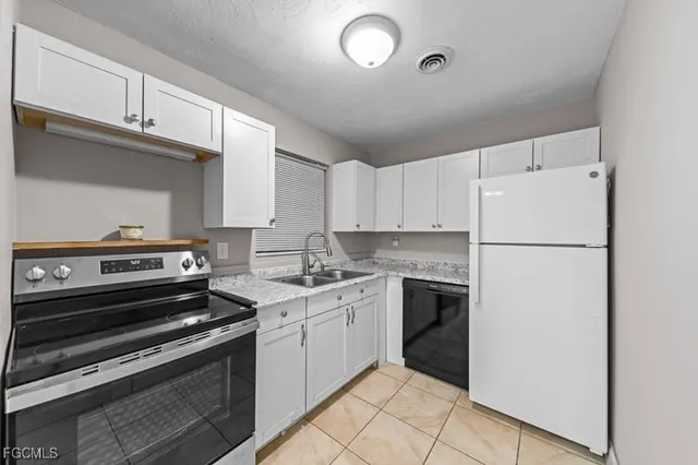 a kitchen with a white cabinets and white appliances