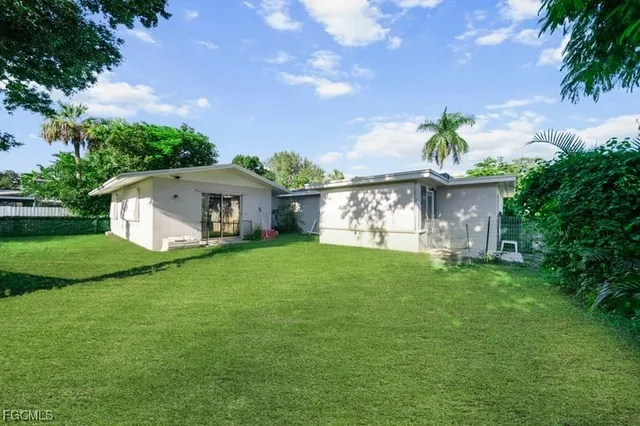 a front view of a house with a garden and yard