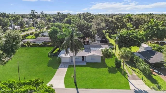 a view of a garden with a building in the background