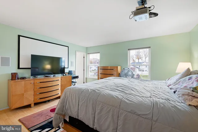 a bedroom with a bed and flat screen tv