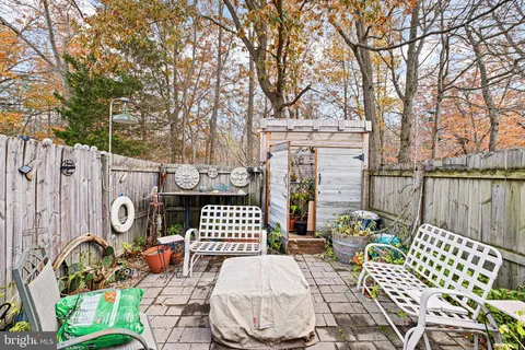 a view of a chairs and table in backyard