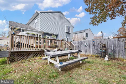 a wooden bench sitting in front of a building