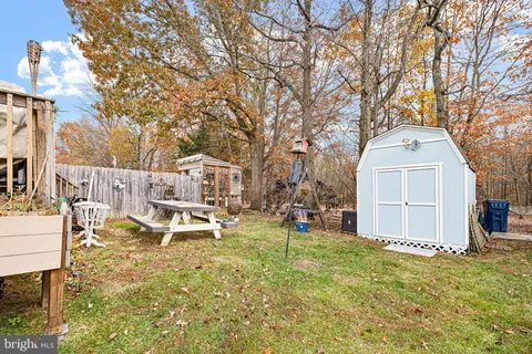 a white house that has a tree in front of it