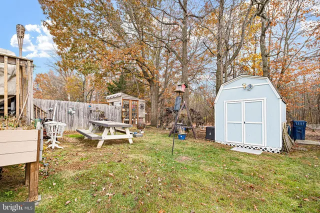 a white house that has a tree in front of it