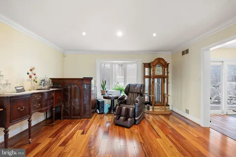 a living room with furniture a fireplace and wooden floor