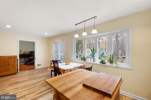 a view of a dining room with furniture a chandelier and wooden floor