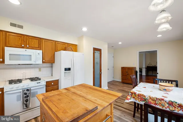 a open kitchen with stainless steel appliances granite countertop a sink refrigerator and cabinets