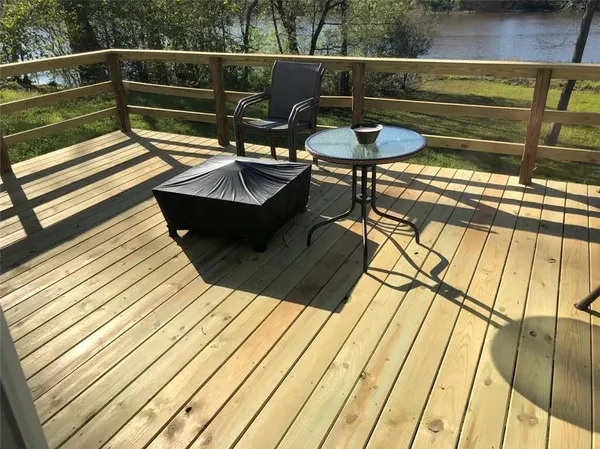 a view of sitting area with furniture and wooden floor