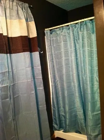 a bathroom with a shower curtain and sink