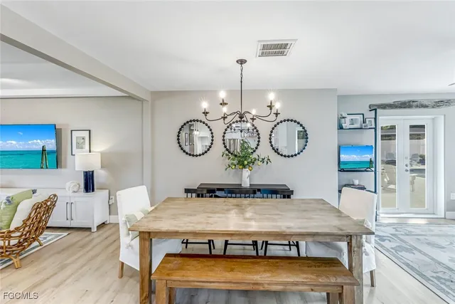 a living room with furniture and chandelier