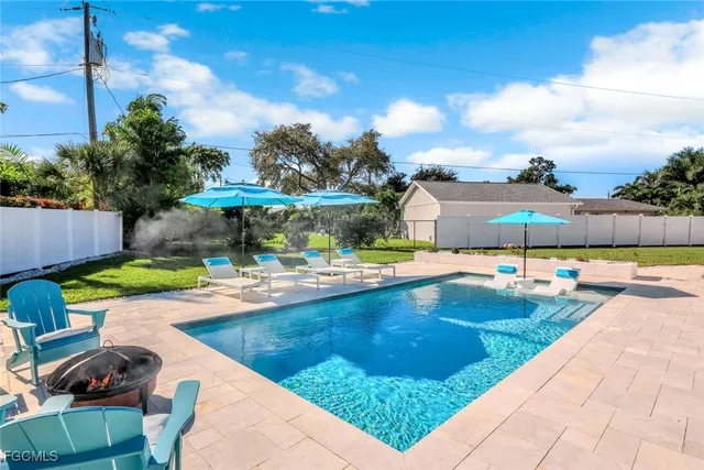 a view of a swimming pool with outdoor seating