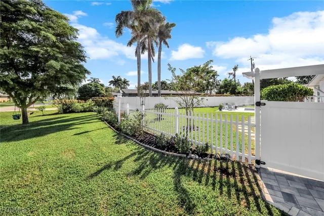 a view of a swimming pool with a patio and a garden