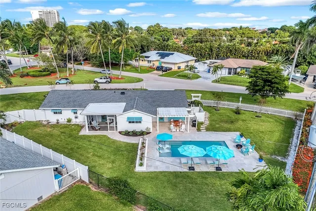 a view of a swimming pool with a patio and a garden