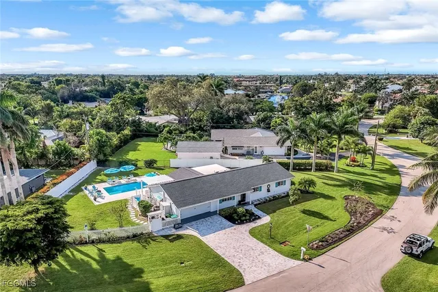 an aerial view of residential houses with outdoor space