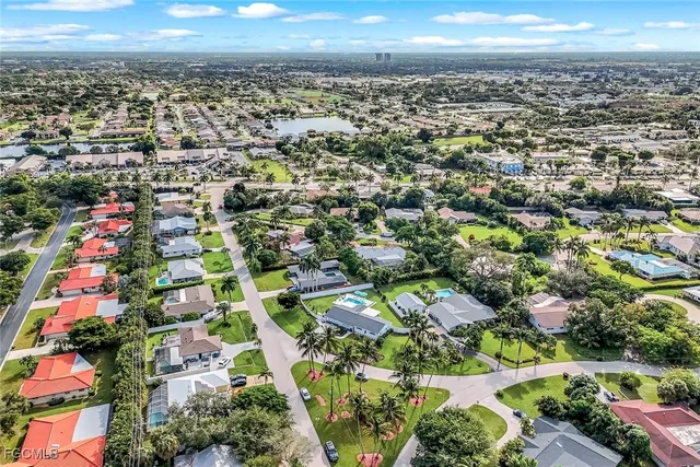 an aerial view of residential houses with outdoor space and street view