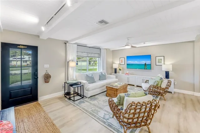 a bedroom with furniture and a large window