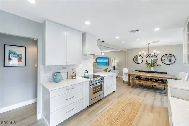 a kitchen with stainless steel appliances a stove a sink and a refrigerator