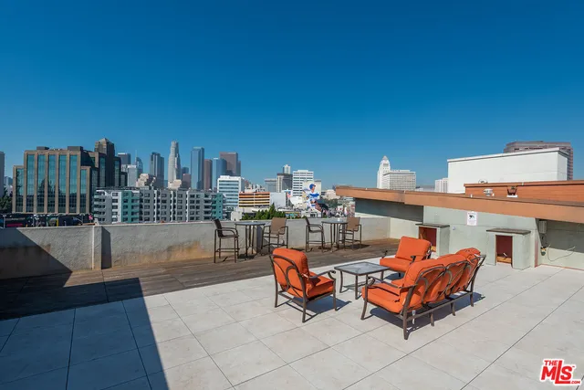 a living room with furniture a city view and buildings