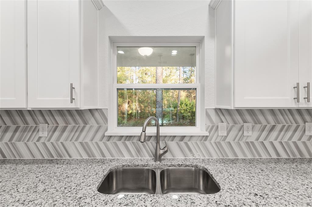 8725 Southwest 136th Terrace Dunnellon, FL 34432 - Photo 29 of 78 a kitchen with a sink and a window