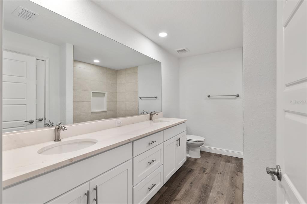 8725 Southwest 136th Terrace Dunnellon, FL 34432 - Photo 40 of 78 a bathroom with a double vanity sink and mirror