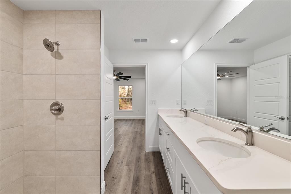 8725 Southwest 136th Terrace Dunnellon, FL 34432 - Photo 41 of 78 a bathroom with a double vanity sink and mirror