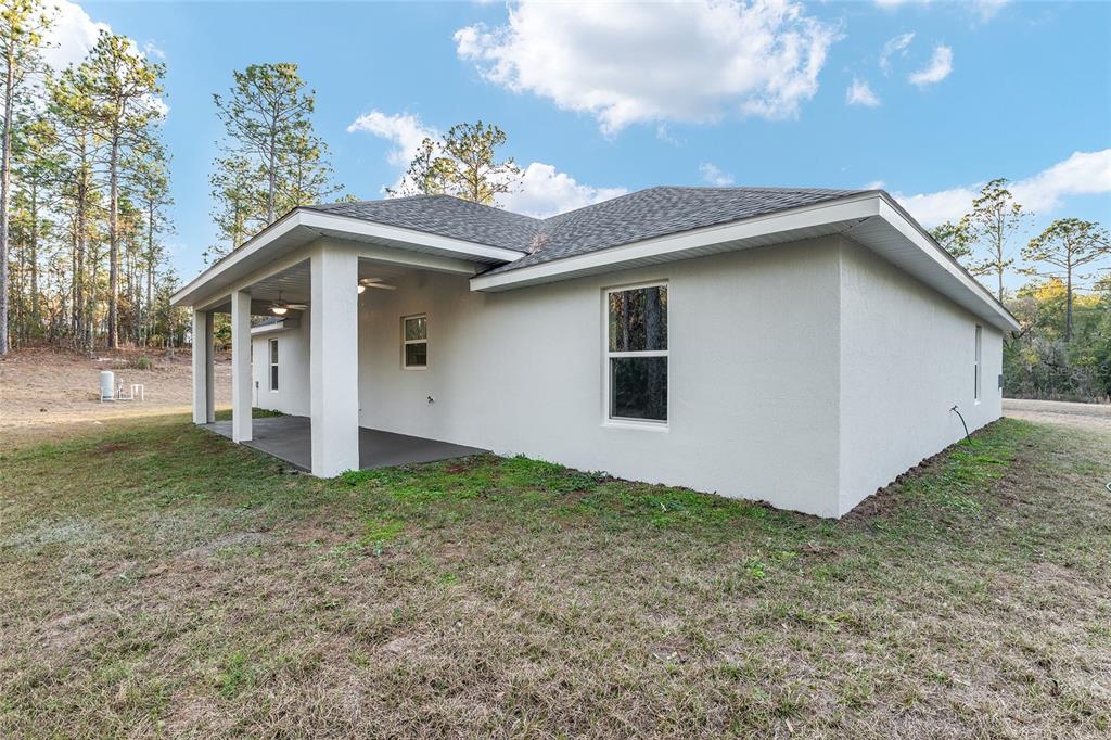 8725 Southwest 136th Terrace Dunnellon, FL 34432 - Photo 64 of 78 a view of a house with a yard
