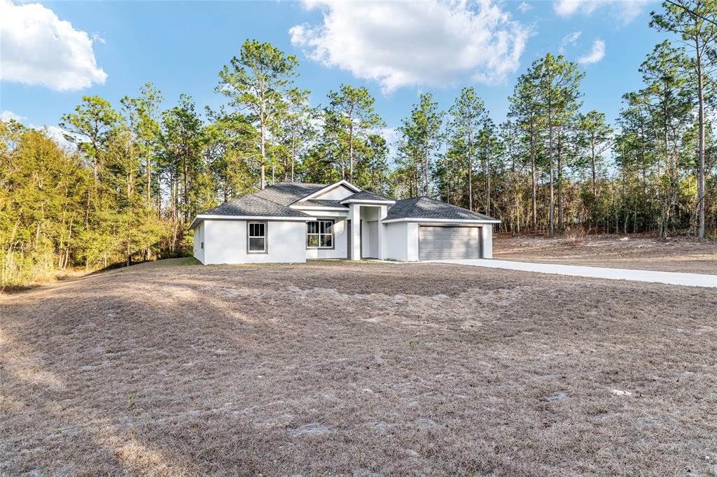 8725 Southwest 136th Terrace Dunnellon, FL 34432 - Photo 8 of 78 a house with trees in the background