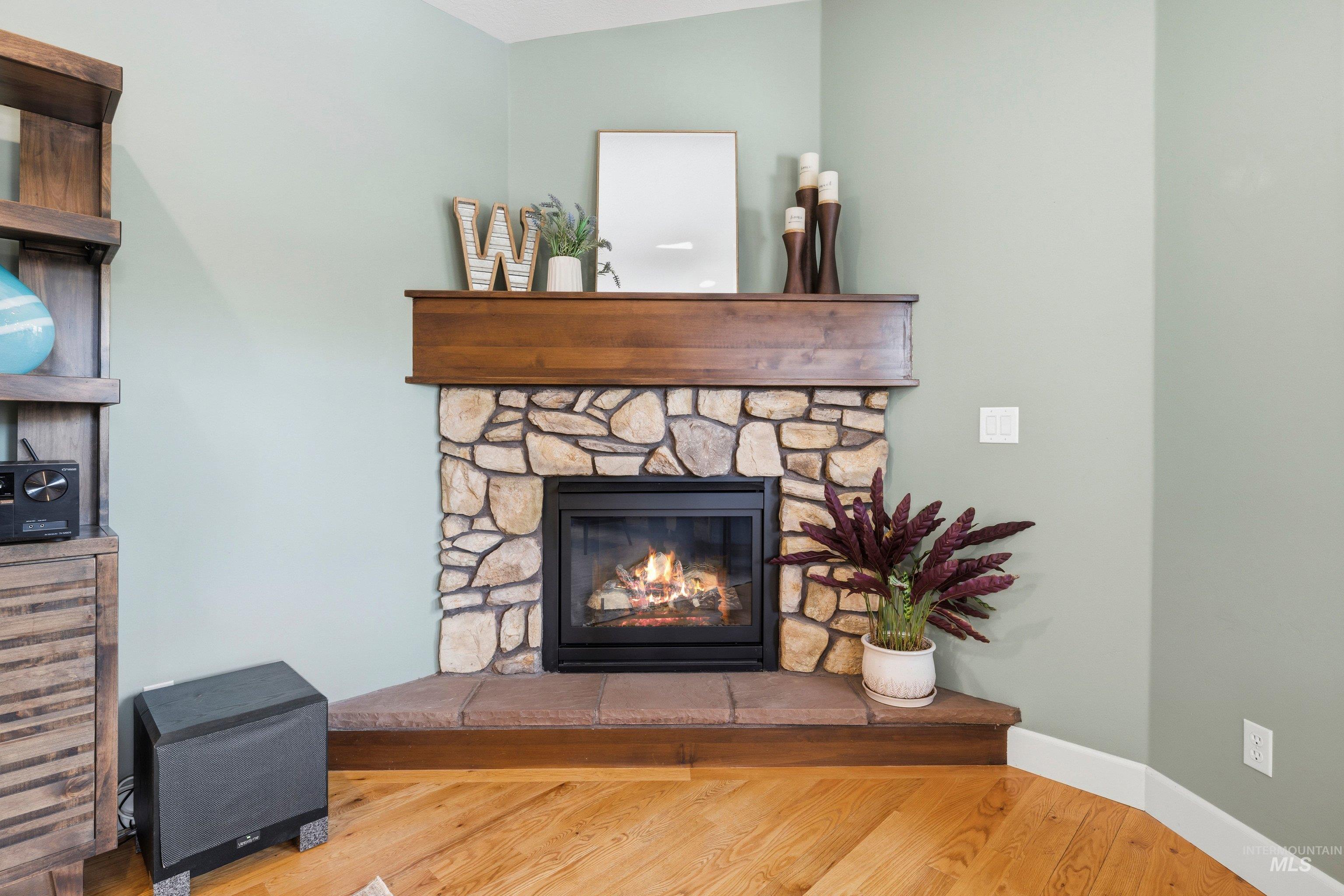 5850 North Rio Lomas Avenue Meridian, ID 83646 - Photo 19 of 50 Detailed view of a stone fireplace and wood finished floors