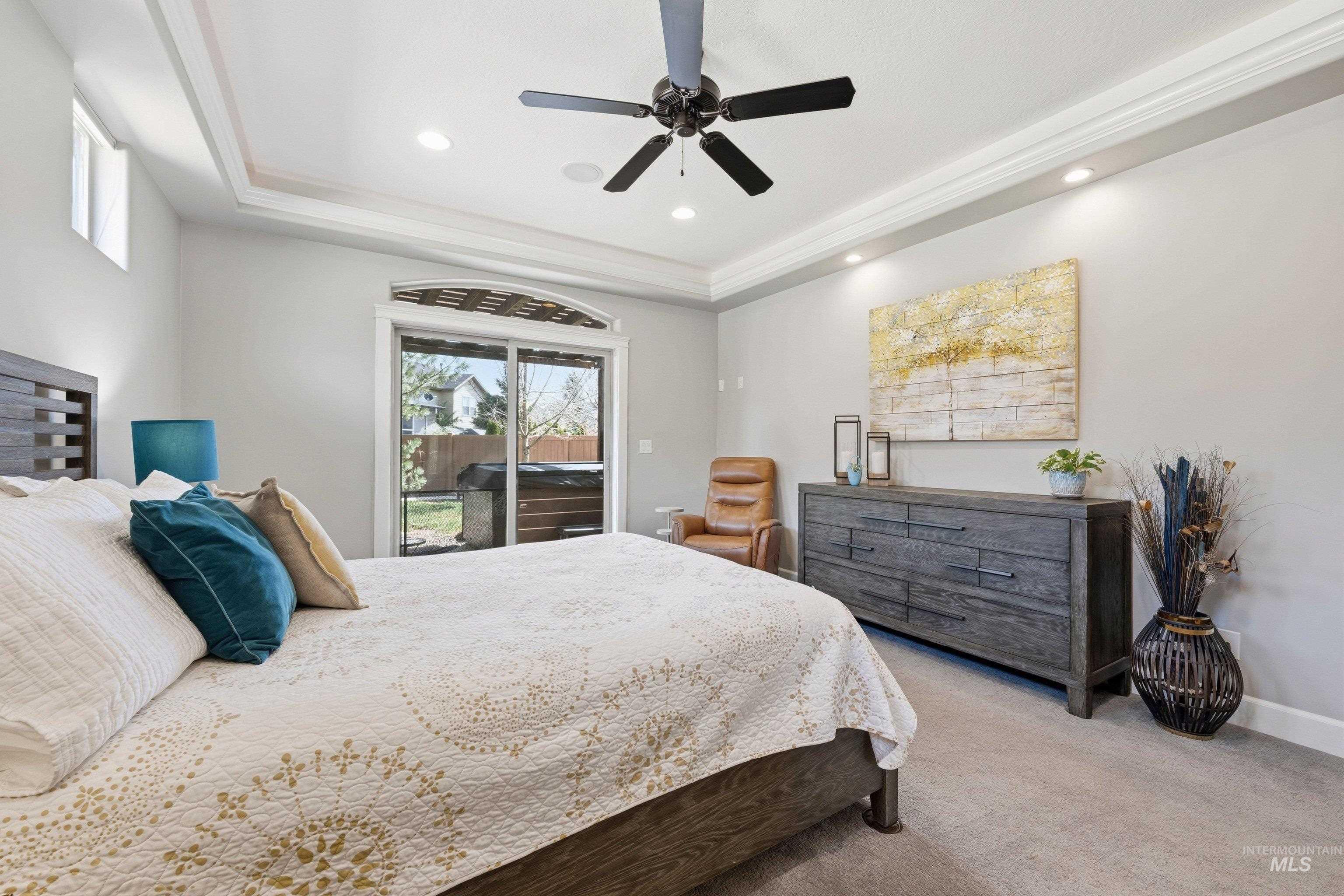 5850 North Rio Lomas Avenue Meridian, ID 83646 - Photo 21 of 50 Bedroom featuring light colored carpet, a tray ceiling, access to outside, a ceiling fan, and recessed lighting
