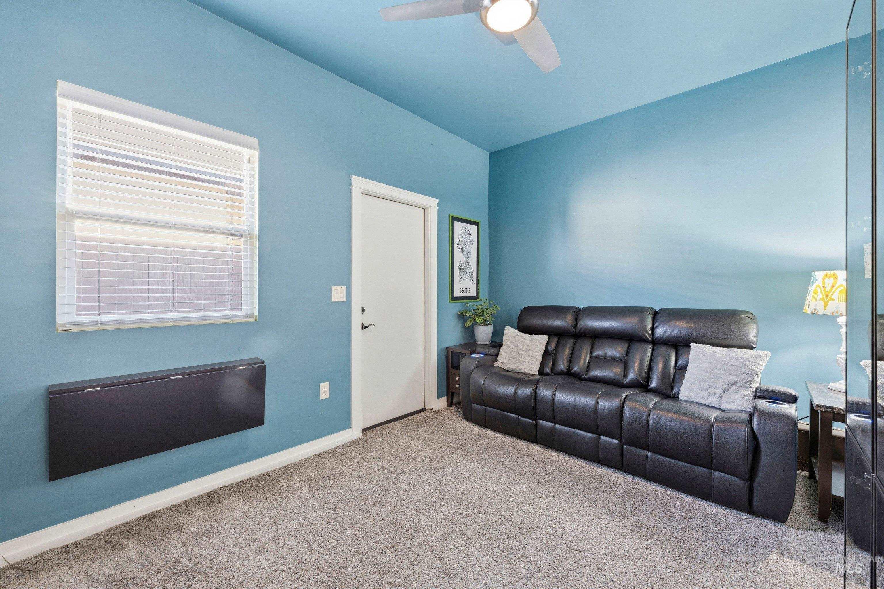 5850 North Rio Lomas Avenue Meridian, ID 83646 - Photo 32 of 50 Carpeted living area with baseboards and a ceiling fan