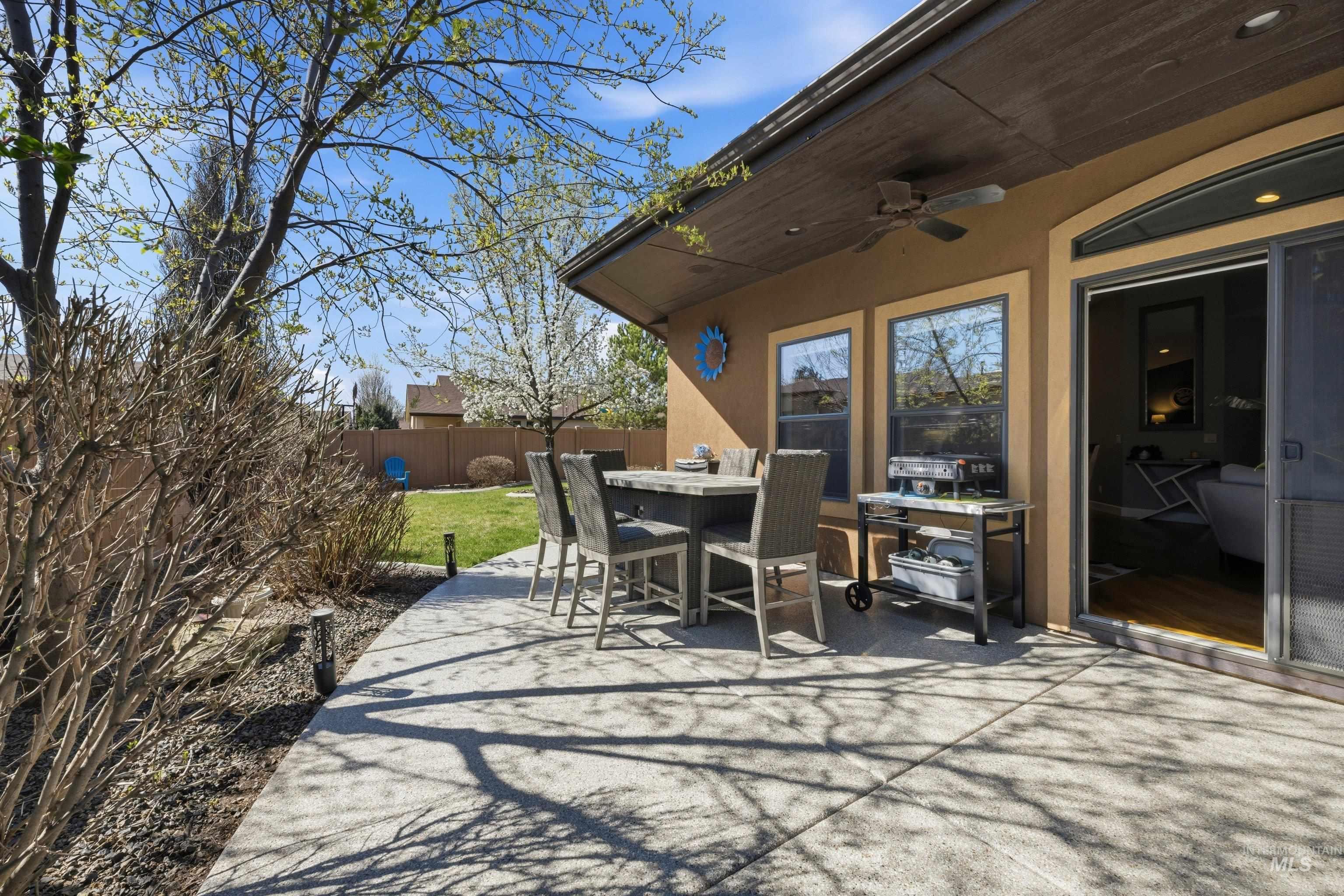 5850 North Rio Lomas Avenue Meridian, ID 83646 - Photo 35 of 50 Fenced backyard featuring a patio, ceiling fan, and outdoor dining space