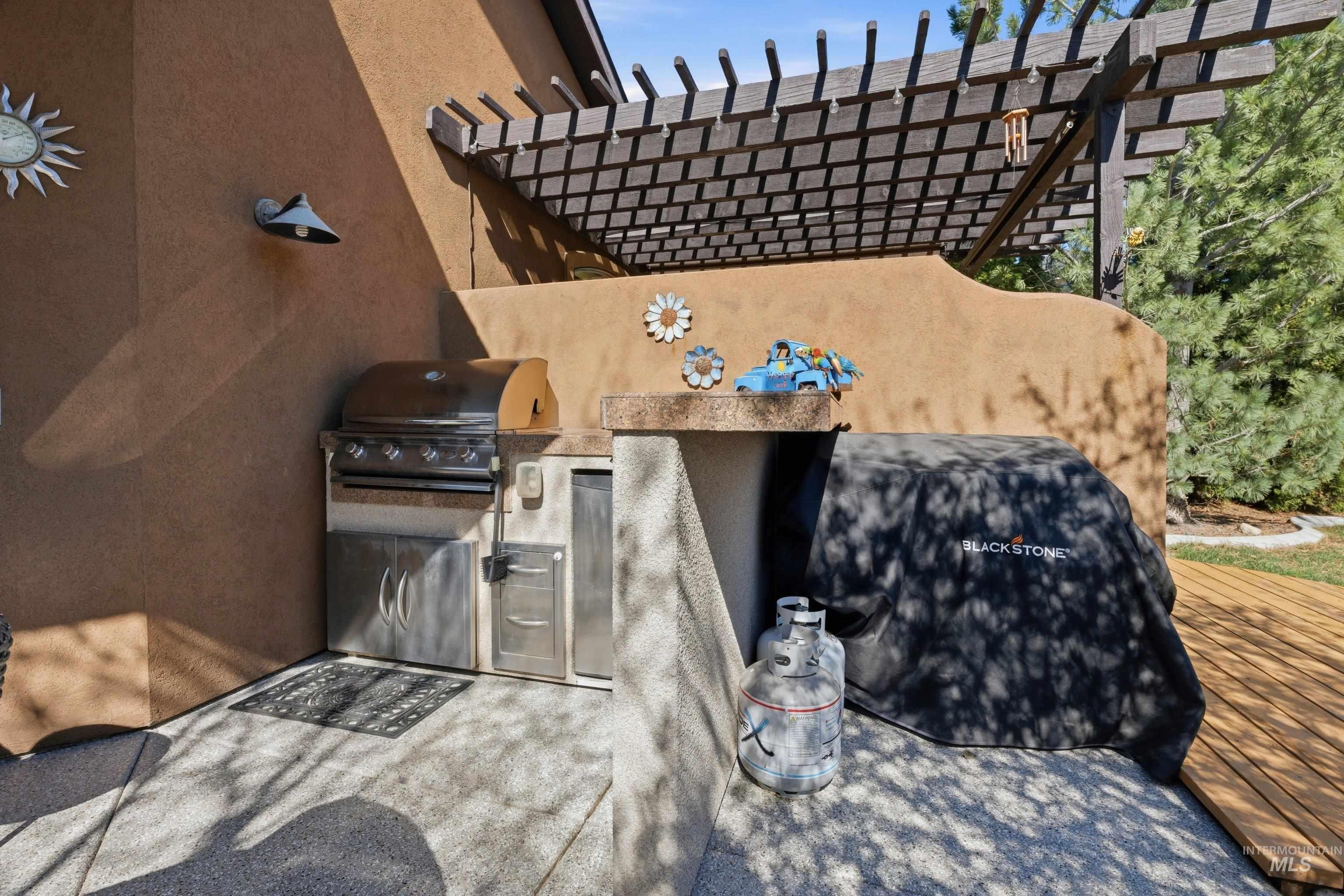 5850 North Rio Lomas Avenue Meridian, ID 83646 - Photo 38 of 50 View of patio featuring exterior kitchen and a pergola