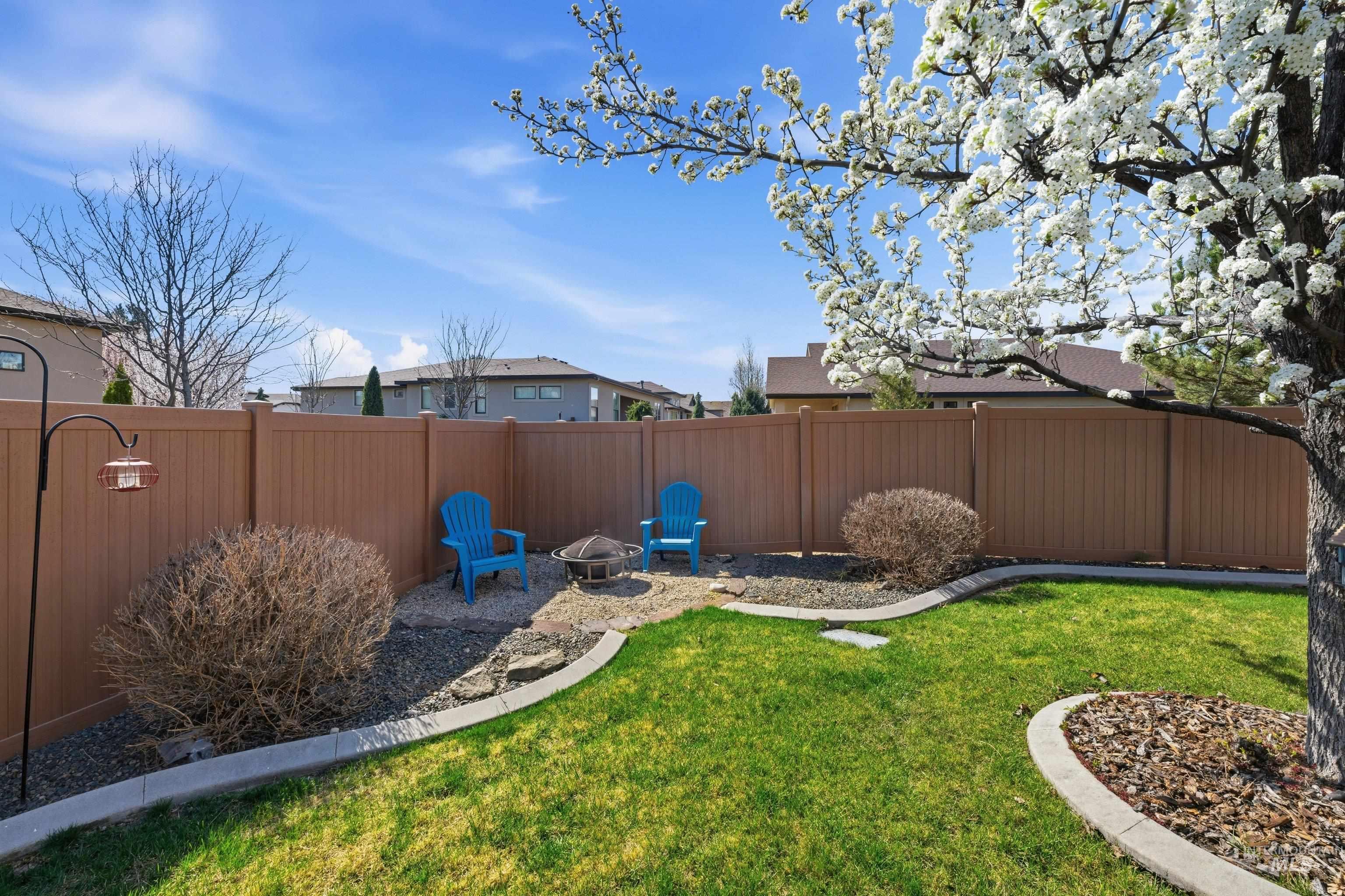 5850 North Rio Lomas Avenue Meridian, ID 83646 - Photo 40 of 50 Fenced backyard with a fire pit and a residential view