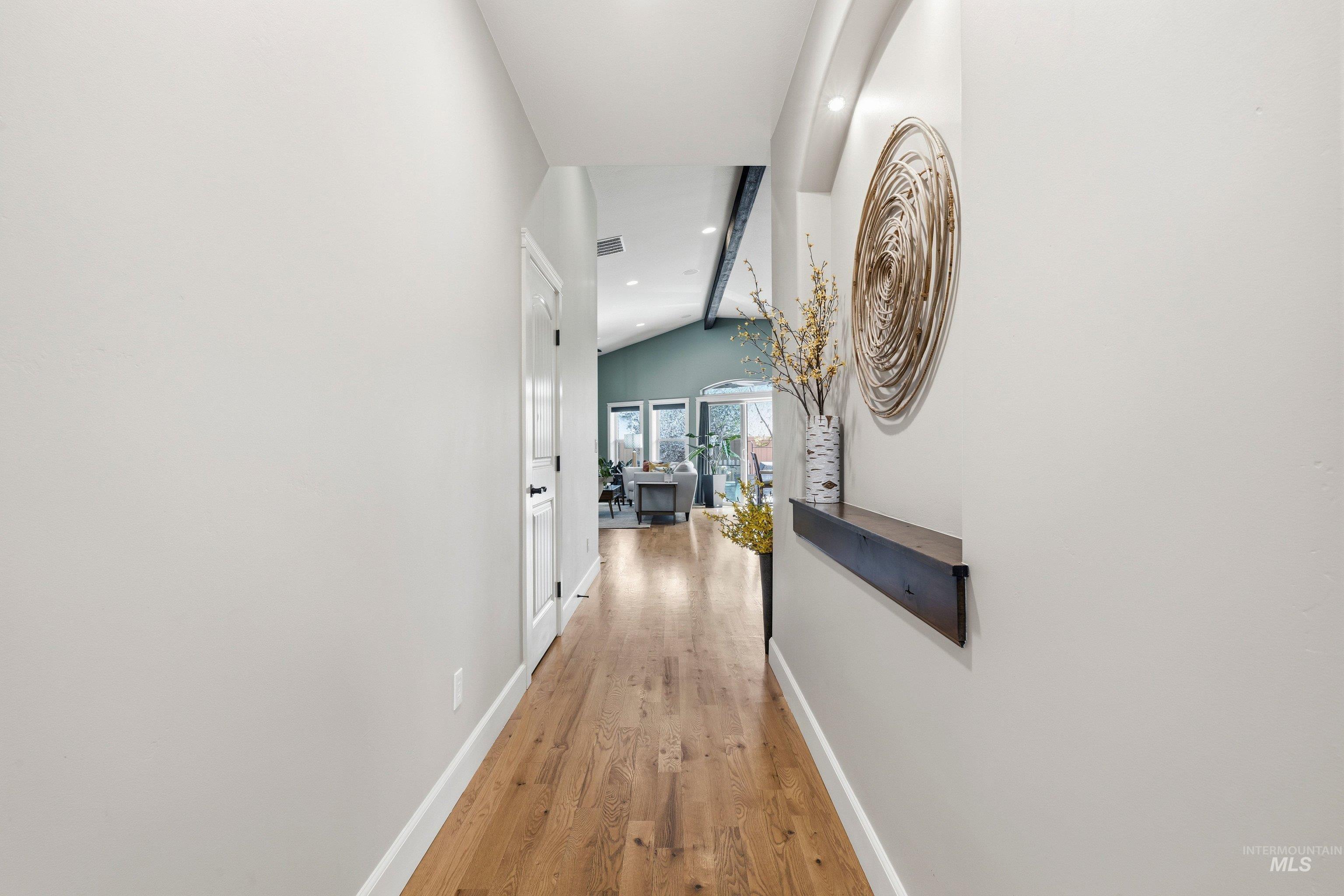 5850 North Rio Lomas Avenue Meridian, ID 83646 - Photo 6 of 50 Hallway featuring light wood-style flooring, recessed lighting, and vaulted ceiling