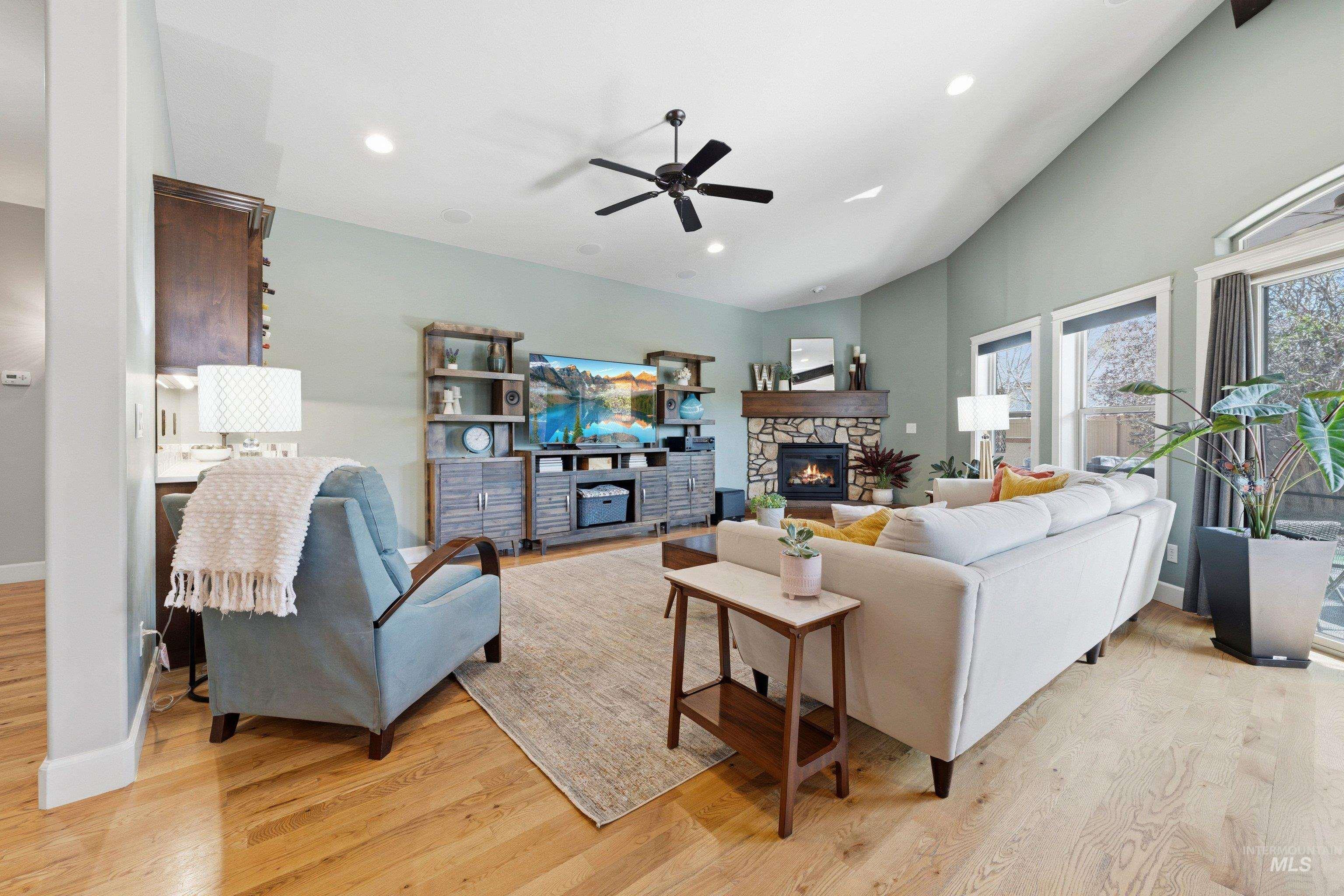 5850 North Rio Lomas Avenue Meridian, ID 83646 - Photo 7 of 50 Living area featuring light wood-type flooring, a ceiling fan, a fireplace, lofted ceiling, and recessed lighting